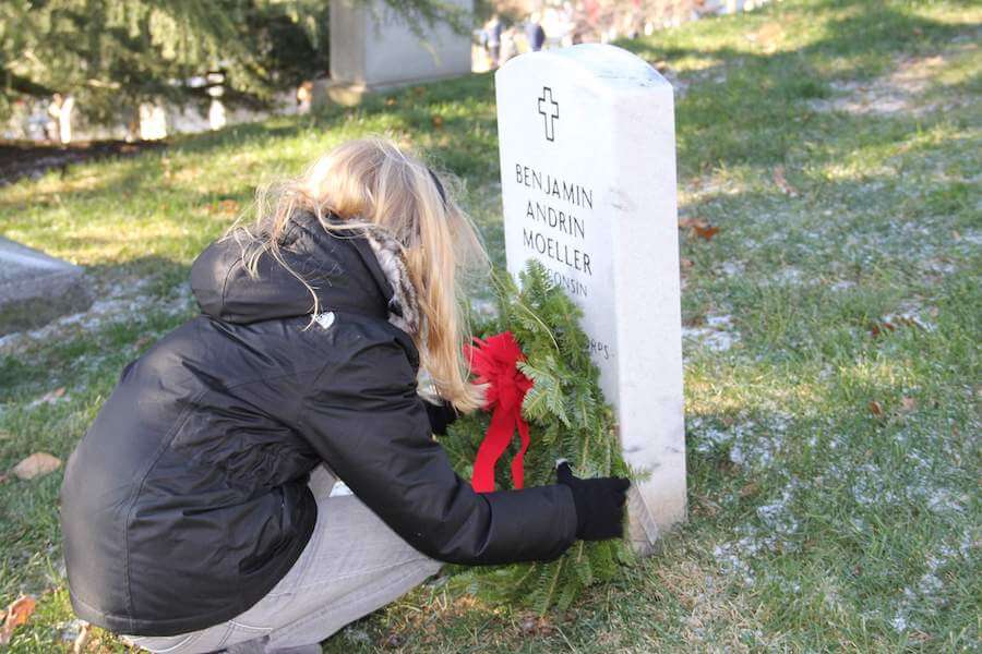Girl places wreath
