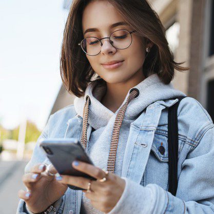 close-up-portrait-tender-romantic-girlfriend-send-cheerful-message-heart-emoji-friend-holding-mobile-phone-smiling-display-texting-with-friend-communicating-while-standing-street_197531-22153