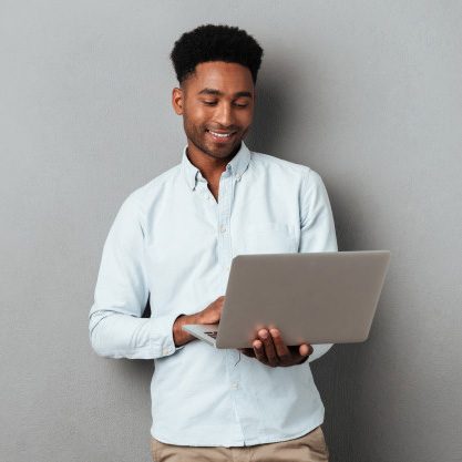 young-smiling-african-man-standing-using-laptop_171337-12867